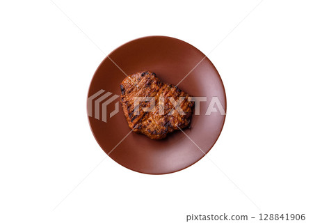 Meat, steak, beef tenderloin cooked on grill. Juicy steak as a food background 128841906