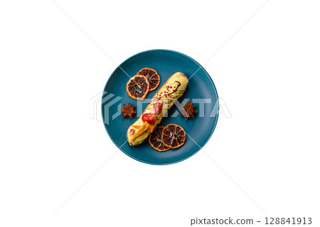 French food, dessert eclair with chocolate filling. Eclair as a background 128841913