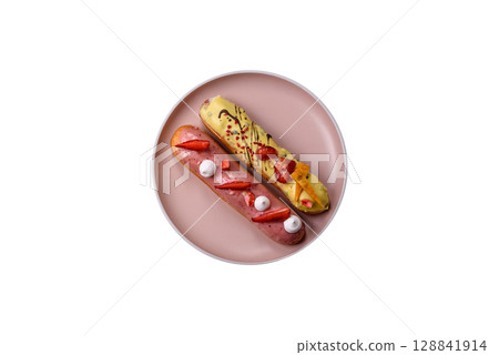 French food, dessert eclair with chocolate filling. Eclair as a background French food, dessert eclair with chocolate filling. Eclair as a background 128841914