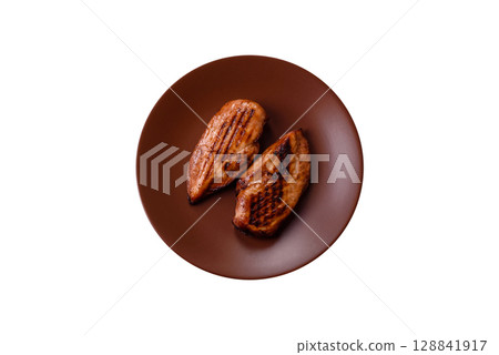 Chicken breast, grilled fillet, meat meal on a plate. Grilled poultry for dinner Chicken breast, grilled fillet, meat meal on a plate. Grilled poultry for dinner 128841917