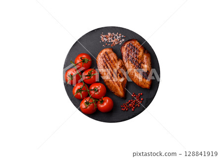 Chicken breast, grilled fillet, meat meal on a plate. Grilled poultry for dinner Chicken breast, grilled fillet, meat meal on a plate. Grilled poultry for dinner 128841919