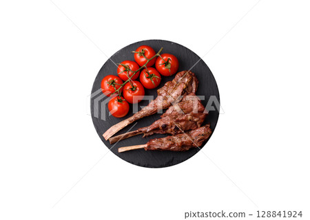 Juicy meat on the bone or rack of lamb. Grilled veal with salt, spices and herbs Juicy meat on the bone or rack of lamb. Grilled veal with salt, spices and herbs 128841924