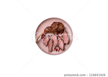 Juicy meat on the bone or rack of lamb. Grilled veal with salt, spices and herbs 128841926
