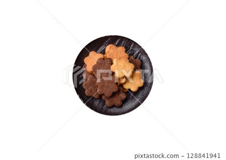Sweet crispy biscuit with cocoa flavor, baking at home. Biscuit as a dessert Sweet crispy biscuit with cocoa flavor, baking at home. Biscuit as a dessert 128841941