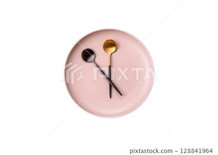 Empty plate with devices in the form of clock hands as a conceptual background for lunch time 128841964