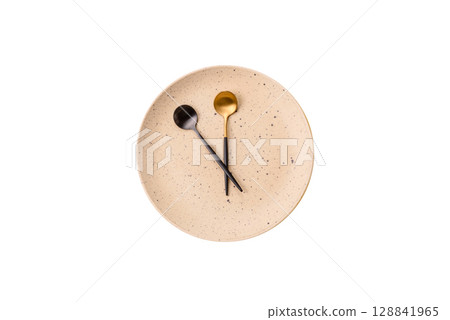Empty plate with devices in the form of clock hands as a conceptual background for lunch time Empty plate with devices in the form of clock hands as a conceptual background for lunch time 128841965