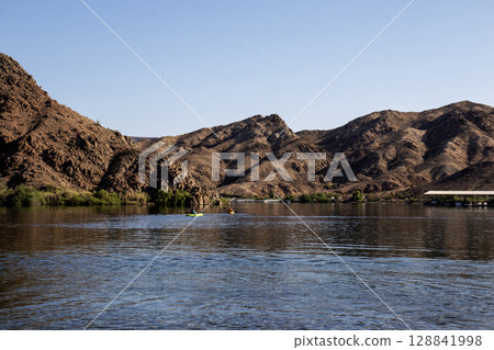 Kayakers Explore Serene Waters Surrounded by Desert Mountains from Willow Beach Arizona Kayakers Explore Serene Waters Surrounded by Desert Mountains from Willow Beach Arizona 128841998