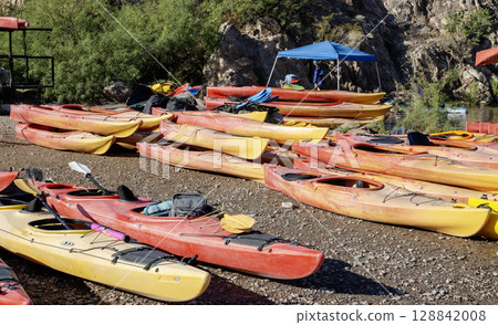 Colorful Kayaks on a Shoreline Ready for Exploration on the Colorado River in Arizona 128842008