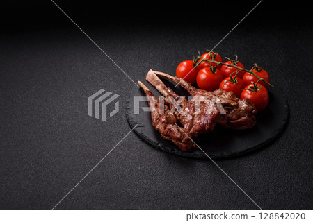 Juicy meat on the bone or rack of lamb. Grilled veal with salt, spices and herbs Juicy meat on the bone or rack of lamb. Grilled veal with salt, spices and herbs 128842020