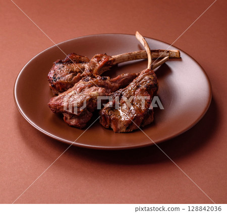 Juicy meat on the bone or rack of lamb. Grilled veal with salt, spices and herbs 128842036