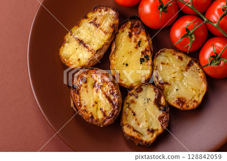 Food, potatoes cut in halves or slices grilled. Cooked baked potatoes Food, potatoes cut in halves or slices grilled. Cooked baked potatoes 128842059