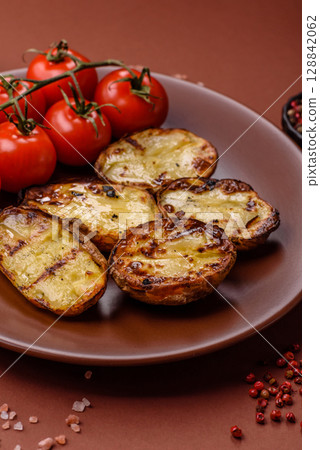 Food, potatoes cut in halves or slices grilled. Cooked baked potatoes Food, potatoes cut in halves or slices grilled. Cooked baked potatoes 128842062