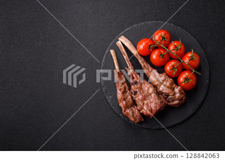 Juicy meat on the bone or rack of lamb. Grilled veal with salt, spices and herbs Juicy meat on the bone or rack of lamb. Grilled veal with salt, spices and herbs 128842063