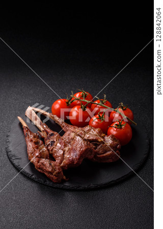 Juicy meat on the bone or rack of lamb. Grilled veal with salt, spices and herbs Juicy meat on the bone or rack of lamb. Grilled veal with salt, spices and herbs 128842064