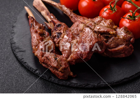 Juicy meat on the bone or rack of lamb. Grilled veal with salt, spices and herbs Juicy meat on the bone or rack of lamb. Grilled veal with salt, spices and herbs 128842065