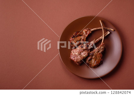 Juicy meat on the bone or rack of lamb. Grilled veal with salt, spices and herbs 128842074