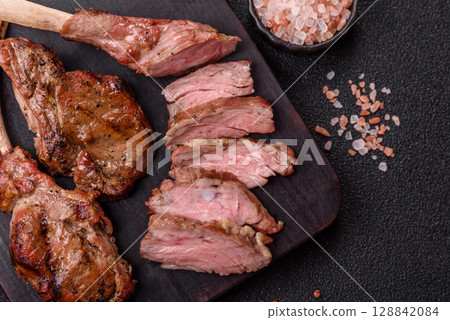 Juicy meat on the bone or rack of lamb. Grilled veal with salt, spices and herbs Juicy meat on the bone or rack of lamb. Grilled veal with salt, spices and herbs 128842084