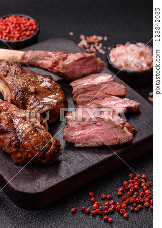 Juicy meat on the bone or rack of lamb. Grilled veal with salt, spices and herbs Juicy meat on the bone or rack of lamb. Grilled veal with salt, spices and herbs 128842085
