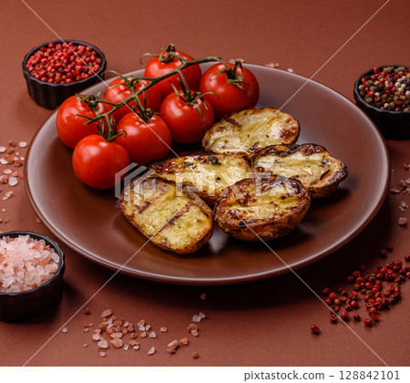 Food, potatoes cut in halves or slices grilled. Cooked baked potatoes Food, potatoes cut in halves or slices grilled. Cooked baked potatoes 128842101