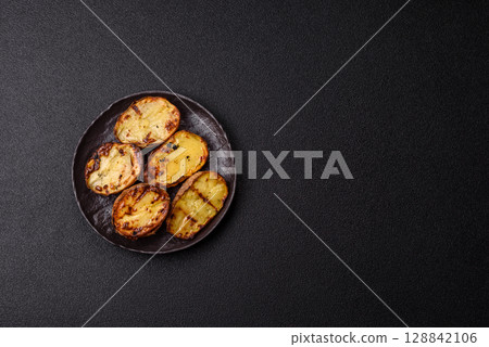 Food, potatoes cut in halves or slices grilled. Cooked baked potatoes Food, potatoes cut in halves or slices grilled. Cooked baked potatoes 128842106