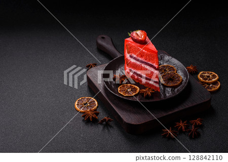 A piece of red velvet cake as a food background. Sweet pastries for celebration A piece of red velvet cake as a food background. Sweet pastries for celebration 128842110