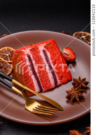 A piece of red velvet cake as a food background. Sweet pastries for celebration A piece of red velvet cake as a food background. Sweet pastries for celebration 128842118