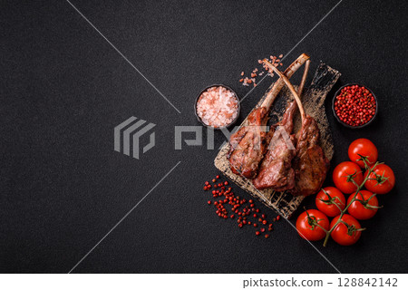 Juicy meat on the bone or rack of lamb. Grilled veal with salt, spices and herbs Juicy meat on the bone or rack of lamb. Grilled veal with salt, spices and herbs 128842142