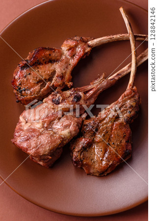 Juicy meat on the bone or rack of lamb. Grilled veal with salt, spices and herbs 128842146