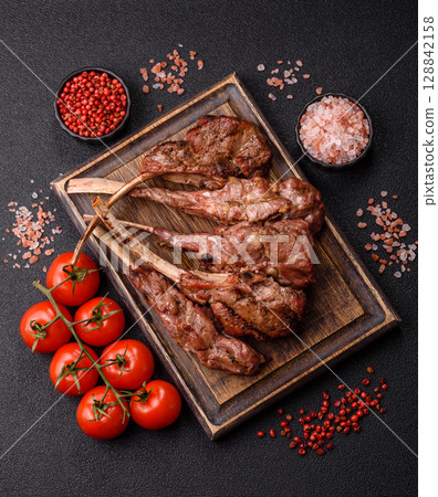 Juicy meat on the bone or rack of lamb. Grilled veal with salt, spices and herbs Juicy meat on the bone or rack of lamb. Grilled veal with salt, spices and herbs 128842158