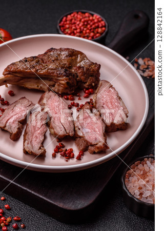 Juicy meat on the bone or rack of lamb. Grilled veal with salt, spices and herbs Juicy meat on the bone or rack of lamb. Grilled veal with salt, spices and herbs 128842164