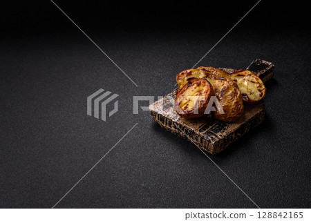 Food, potatoes cut in halves or slices grilled. Cooked baked potatoes Food, potatoes cut in halves or slices grilled. Cooked baked potatoes 128842165