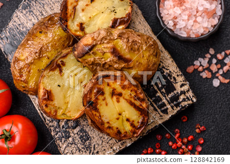 Food, potatoes cut in halves or slices grilled. Cooked baked potatoes Food, potatoes cut in halves or slices grilled. Cooked baked potatoes 128842169