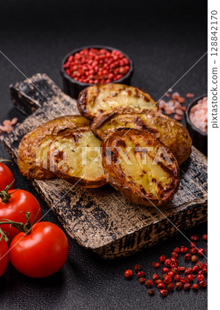Food, potatoes cut in halves or slices grilled. Cooked baked potatoes 128842170
