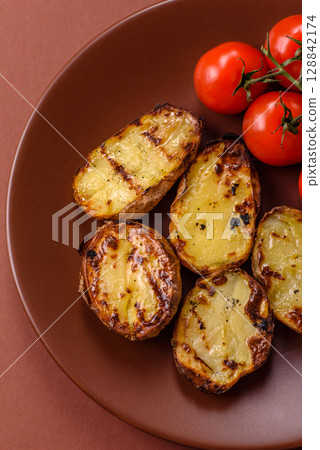 Food, potatoes cut in halves or slices grilled. Cooked baked potatoes 128842174