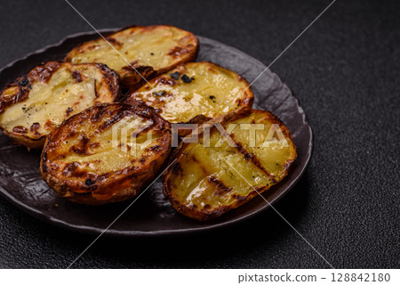 Food, potatoes cut in halves or slices grilled. Cooked baked potatoes Food, potatoes cut in halves or slices grilled. Cooked baked potatoes 128842180