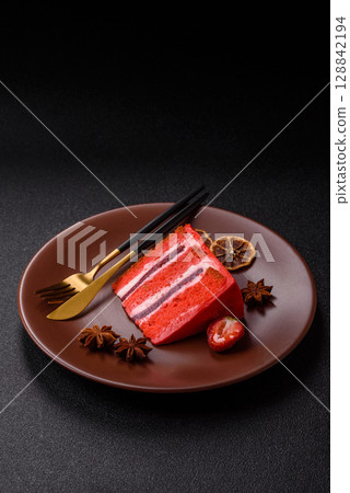A piece of red velvet cake as a food background. Sweet pastries for celebration 128842194