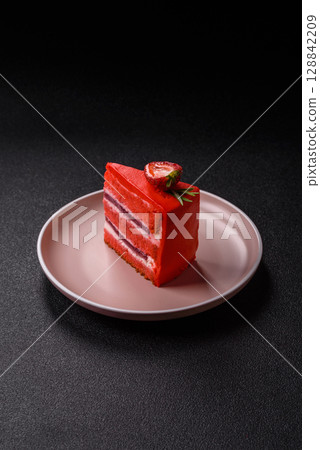 A piece of red velvet cake as a food background. Sweet pastries for celebration A piece of red velvet cake as a food background. Sweet pastries for celebration 128842209