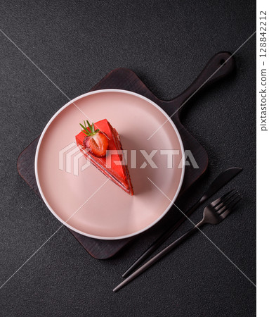 A piece of red velvet cake as a food background. Sweet pastries for celebration A piece of red velvet cake as a food background. Sweet pastries for celebration 128842212