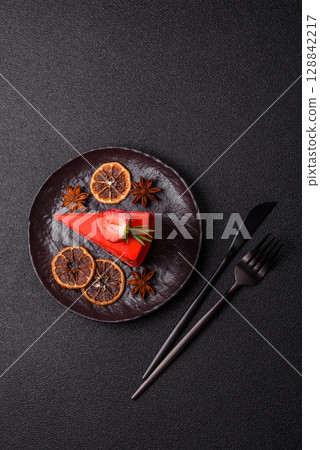 A piece of red velvet cake as a food background. Sweet pastries for celebration 128842217