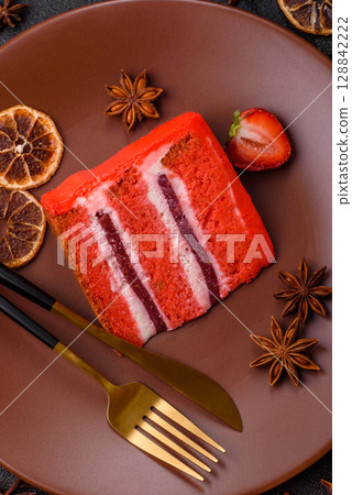 A piece of red velvet cake as a food background. Sweet pastries for celebration A piece of red velvet cake as a food background. Sweet pastries for celebration 128842222