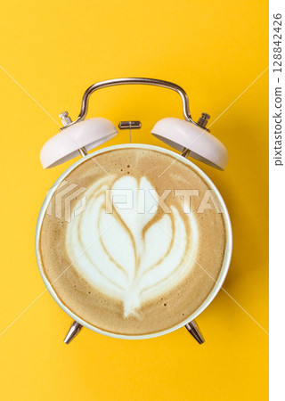 It's coffee time, the signal to drink your morning cappuccino or latte. Concept with a cup of coffee It's coffee time, the signal to drink your morning cappuccino or latte. Concept with a cup of coffee 128842426