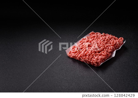 Raw ground beef or pork as an ingredient for burgers. Raw minced meat 128842429