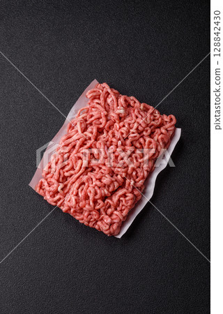Raw ground beef or pork as an ingredient for burgers. Raw minced meat 128842430