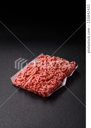 Raw ground beef or pork as an ingredient for burgers. Raw minced meat 128842431