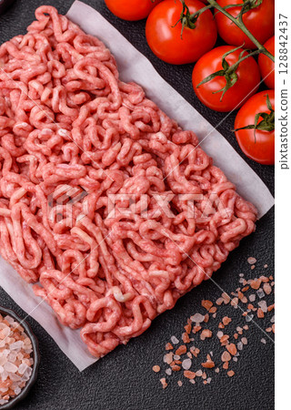Raw ground beef or pork as an ingredient for burgers. Raw minced meat 128842437