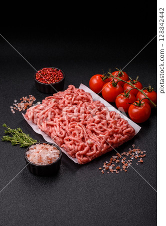 Raw ground beef or pork as an ingredient for burgers. Raw minced meat Raw ground beef or pork as an ingredient for burgers. Raw minced meat 128842442