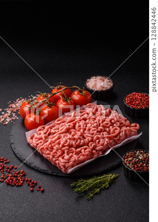 Raw ground beef or pork as an ingredient for burgers. Raw minced meat 128842446