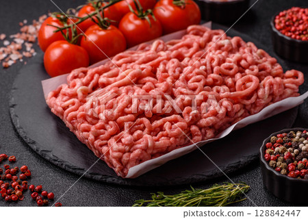 Raw ground beef or pork as an ingredient for burgers. Raw minced meat 128842447