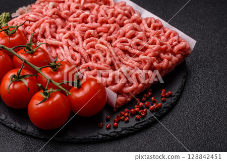 Raw ground beef or pork as an ingredient for burgers. Raw minced meat 128842451