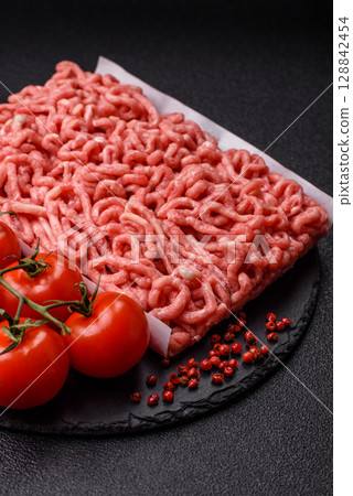 Raw ground beef or pork as an ingredient for burgers. Raw minced meat 128842454